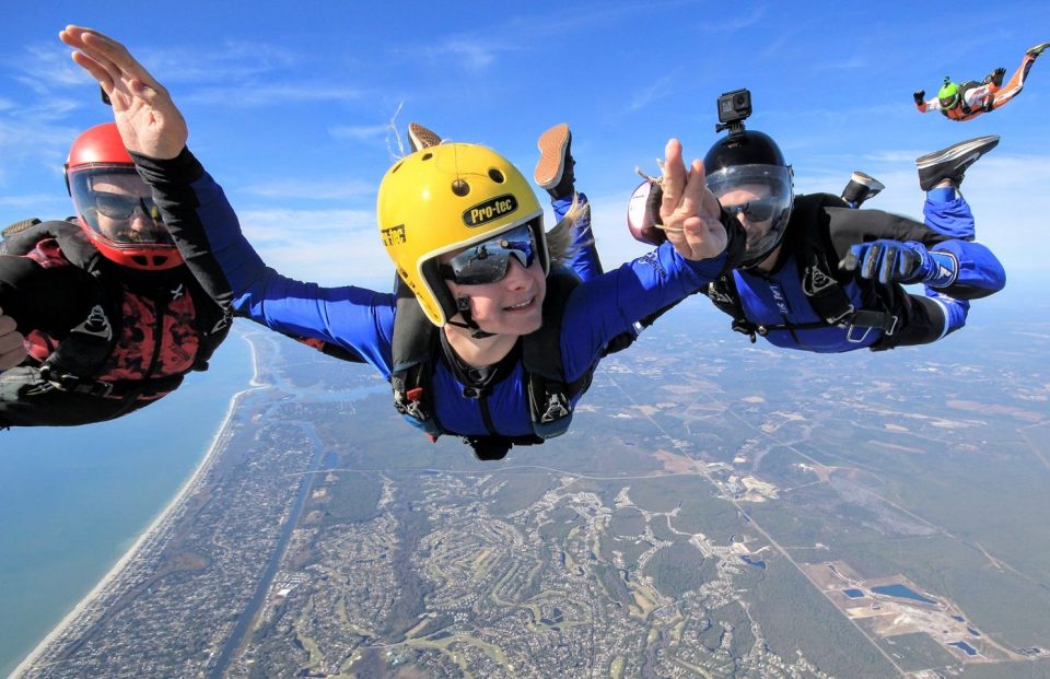 Accelerated freefall student accompanied by instructor on main side and reserve side