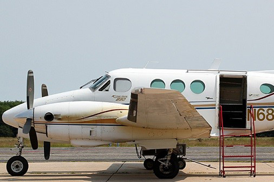 Front of White Beechcraft King Air with loading steps at the door